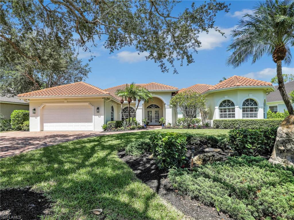 6862 Mill Run Road Naples, FL 34109 - Photo 1 of 50 Living room featuring hardwood / wood-style floors, french doors, ceiling fan with notable chandelier, and vaulted ceiling
