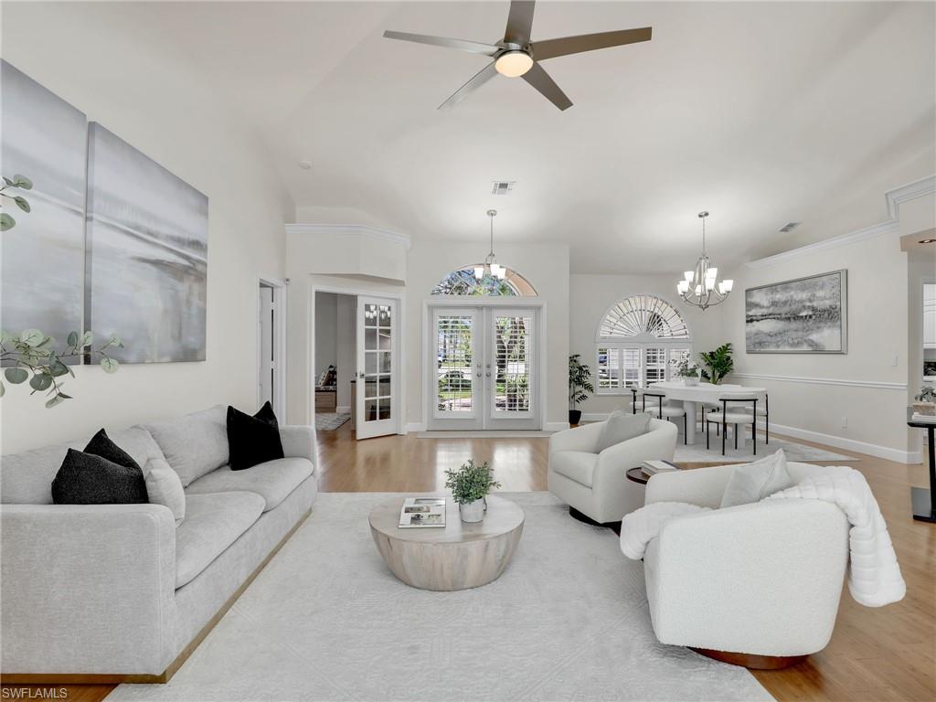 6862 Mill Run Road Naples, FL 34109 - Photo 2 of 50 Dining room with light hardwood / wood-style flooring, ceiling fan with notable chandelier, and vaulted ceiling