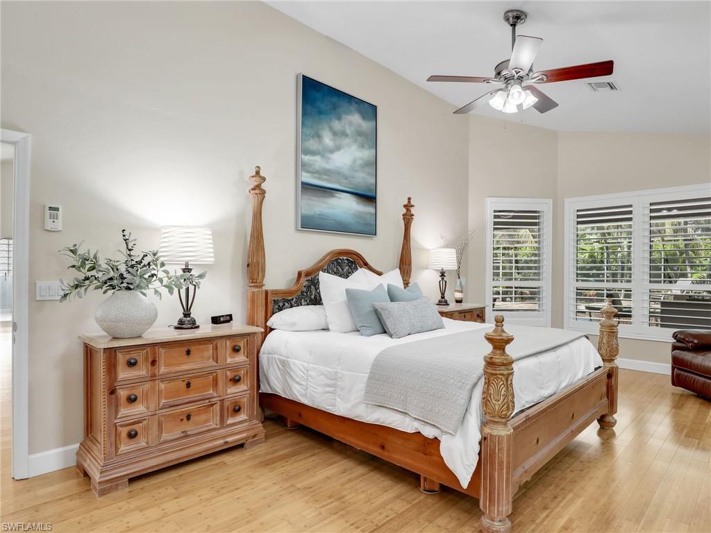 6862 Mill Run Road Naples, FL 34109 - Photo 22 of 50 Bedroom with ceiling fan, light wood-type flooring, multiple windows, and lofted ceiling