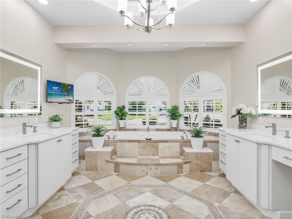 6862 Mill Run Road Naples, FL 34109 - Photo 25 of 50 Bathroom featuring a tray ceiling, crown molding, and a shower with shower door