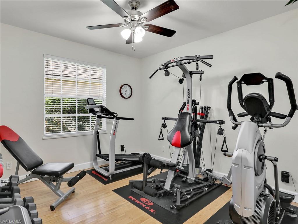 6862 Mill Run Road Naples, FL 34109 - Photo 36 of 50 Bedroom with ceiling fan, light wood-type flooring, and stacked washer and clothes dryer