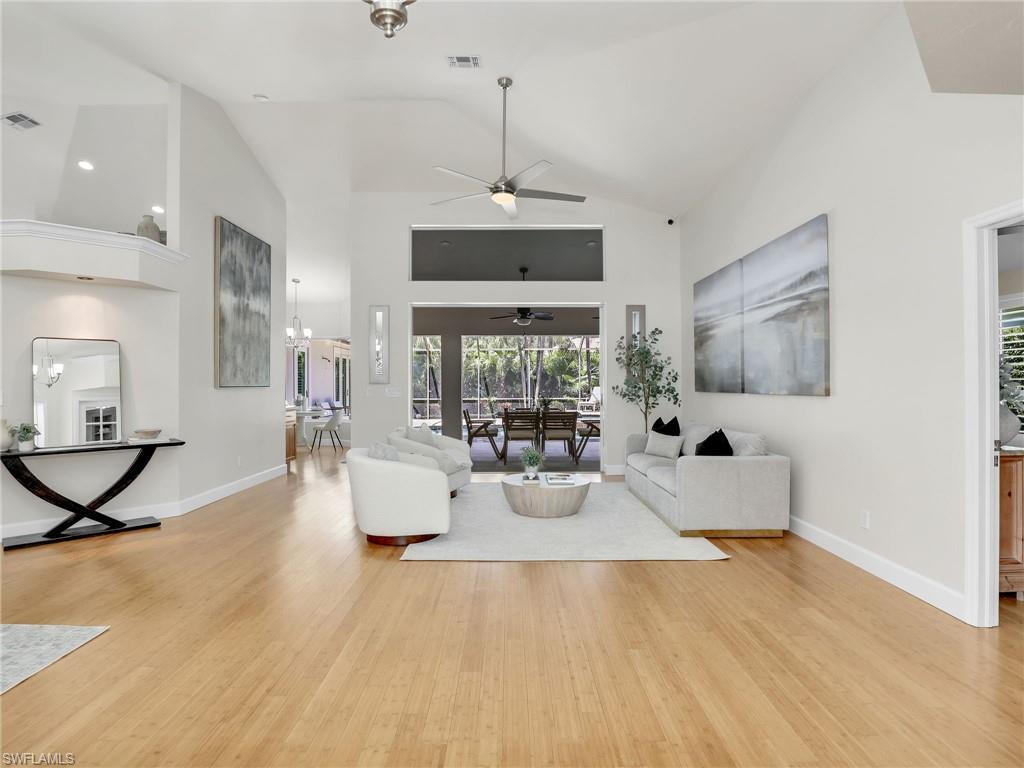 6862 Mill Run Road Naples, FL 34109 - Photo 6 of 50 Living room featuring ceiling fan, high vaulted ceiling, and wood-type flooring