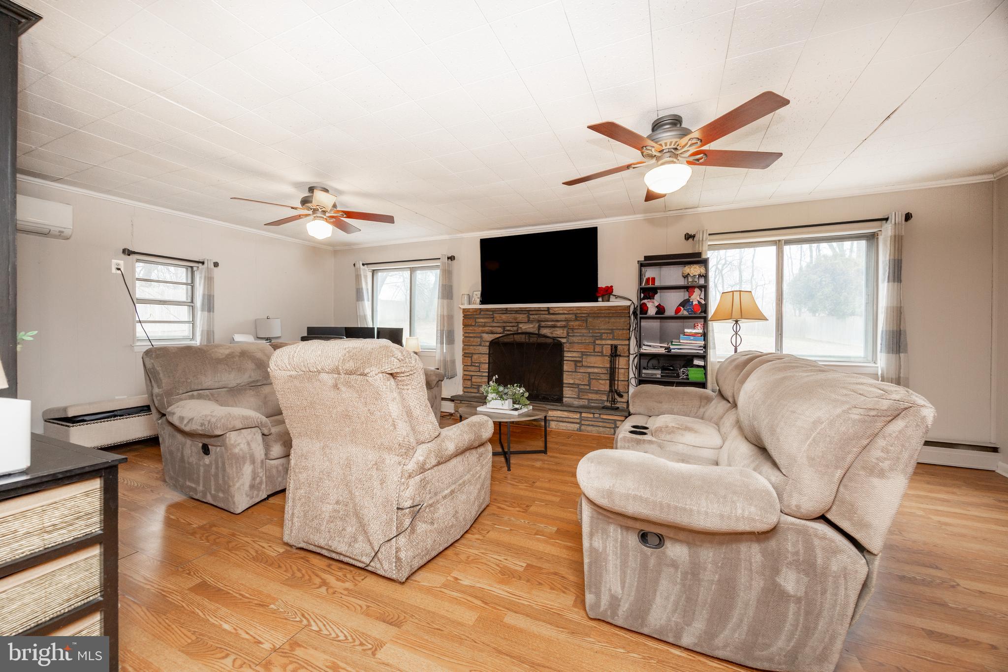 149 Conestoga Road Malvern, PA 19355 - Photo 11 of 43 a living room with furniture a fireplace and a flat screen tv