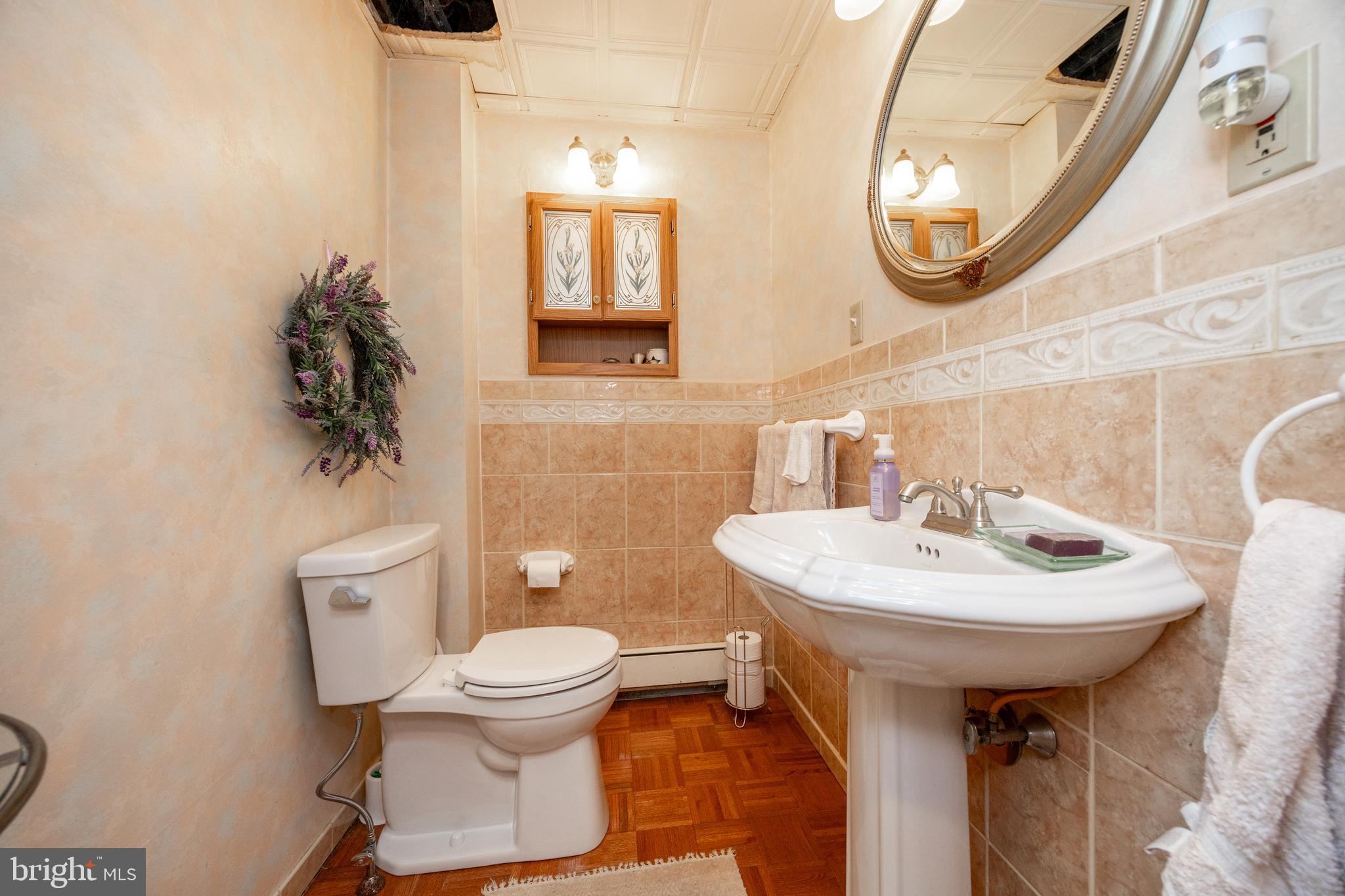149 Conestoga Road Malvern, PA 19355 - Photo 14 of 43 a bathroom with a sink toilet and a mirror