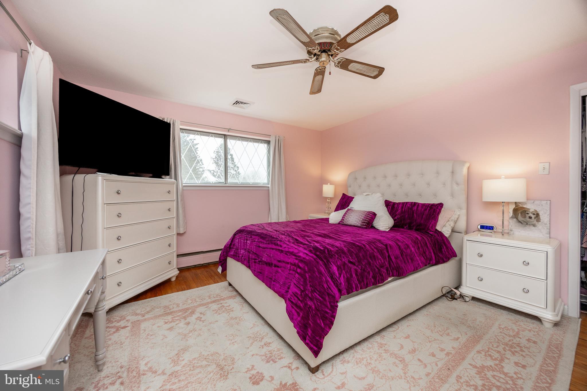 149 Conestoga Road Malvern, PA 19355 - Photo 18 of 43 a spacious bedroom with a bed and a flat screen tv