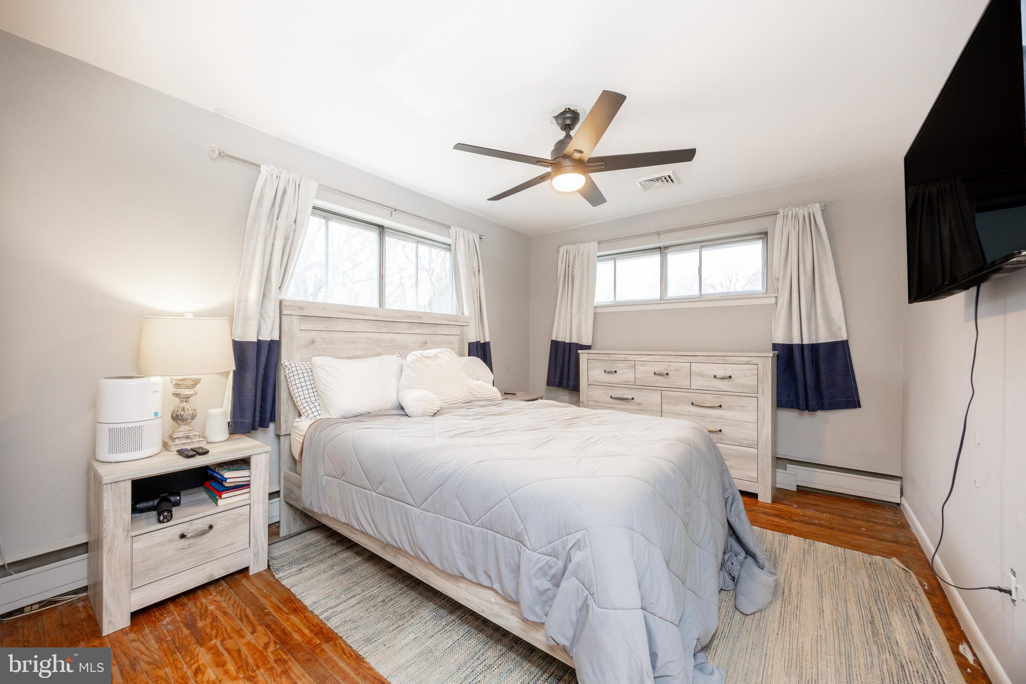149 Conestoga Road Malvern, PA 19355 - Photo 22 of 43 a bedroom with a bed a flat screen tv and window