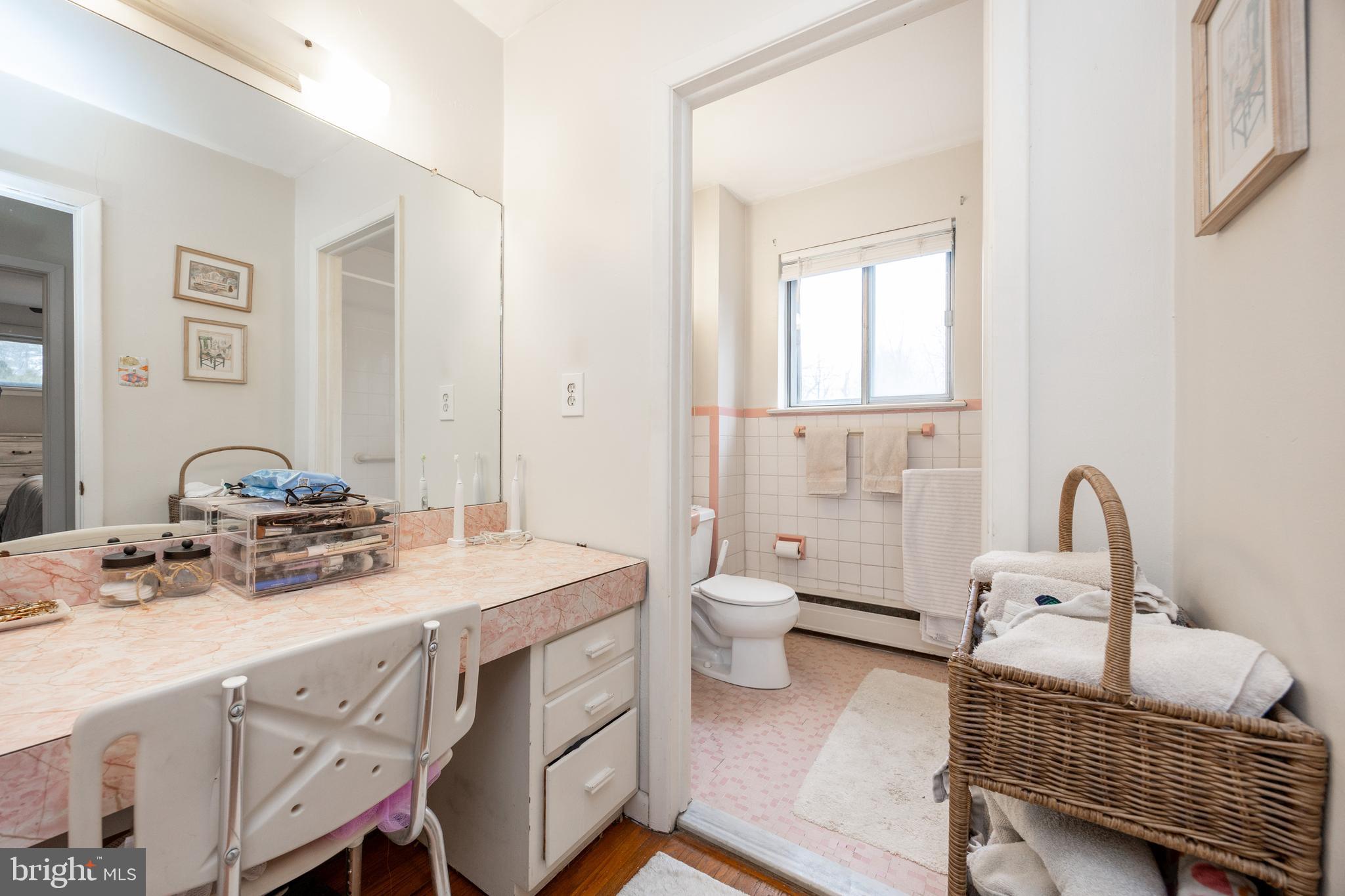 149 Conestoga Road Malvern, PA 19355 - Photo 23 of 43 a spacious bathroom with a granite countertop sink a mirror and toilet