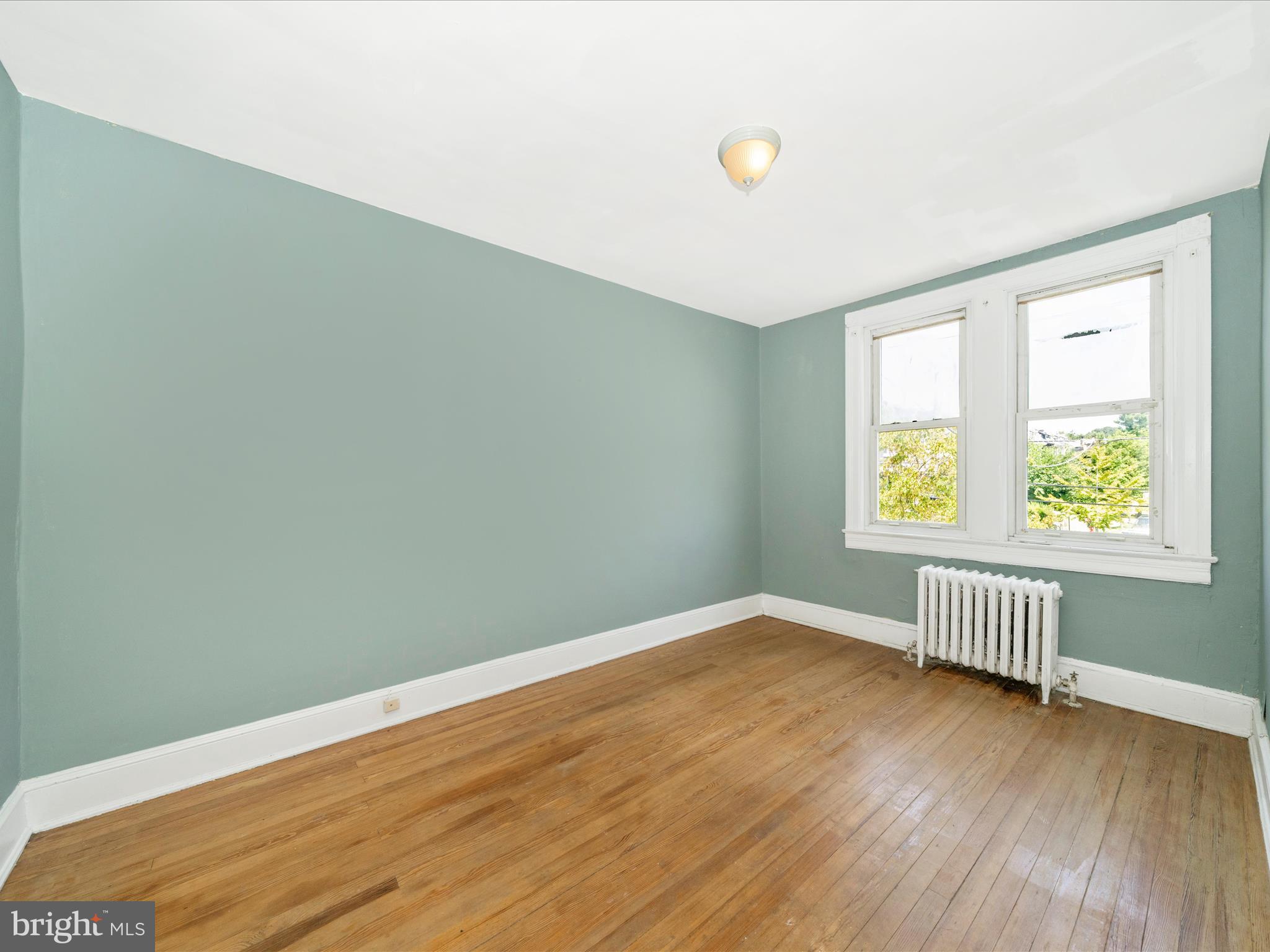 4818 7th Street Northwest Washington, DC 20011 - Photo 12 of 31 an empty room with wooden floor and windows