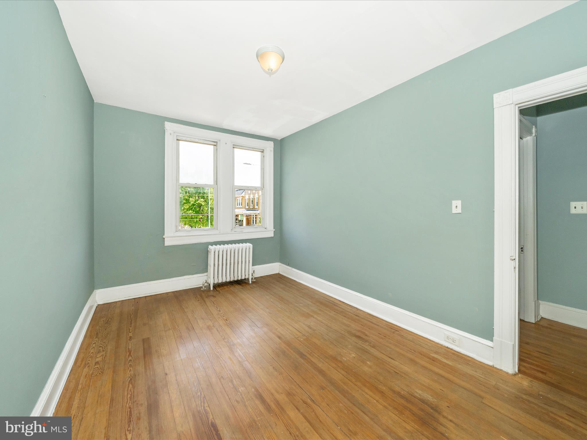 4818 7th Street Northwest Washington, DC 20011 - Photo 13 of 31 an empty room with wooden floor and windows