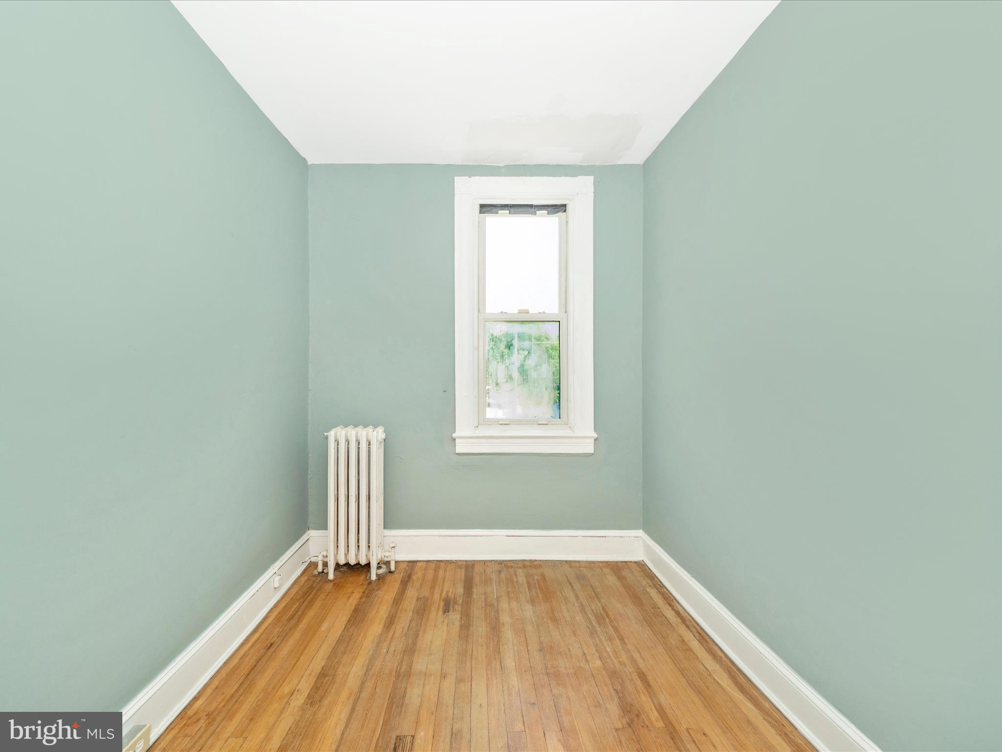 4818 7th Street Northwest Washington, DC 20011 - Photo 17 of 31 an empty room with wooden floor and windows
