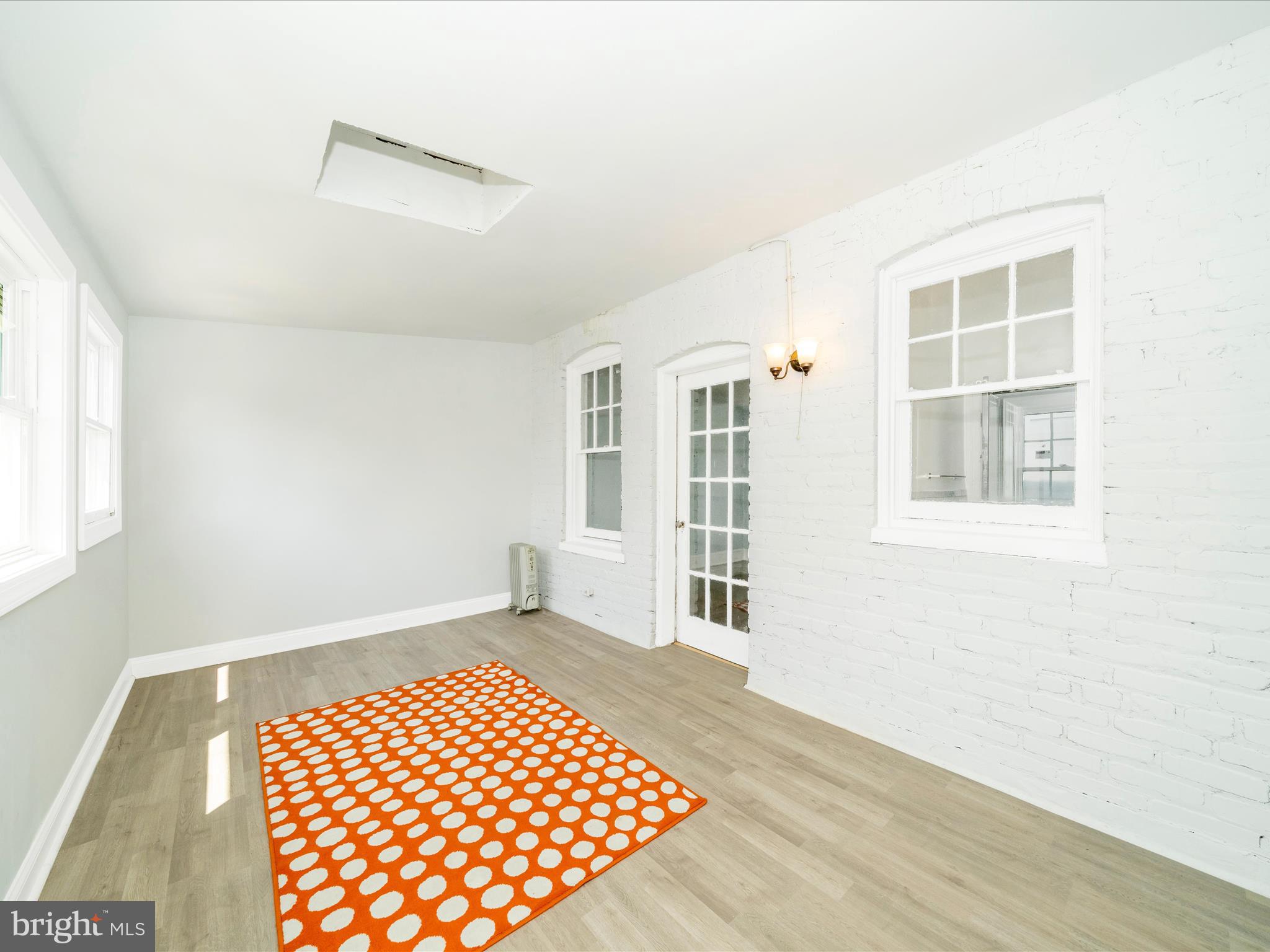 4818 7th Street Northwest Washington, DC 20011 - Photo 22 of 31 a view of an empty room with wooden floor and a window