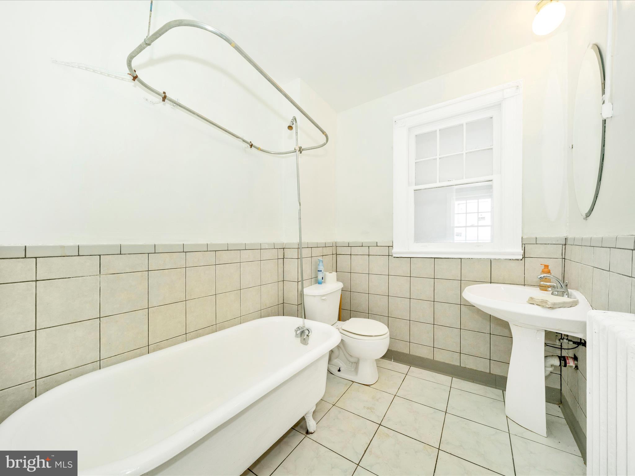 4818 7th Street Northwest Washington, DC 20011 - Photo 24 of 31 a bathroom with a sink a bathtub and window