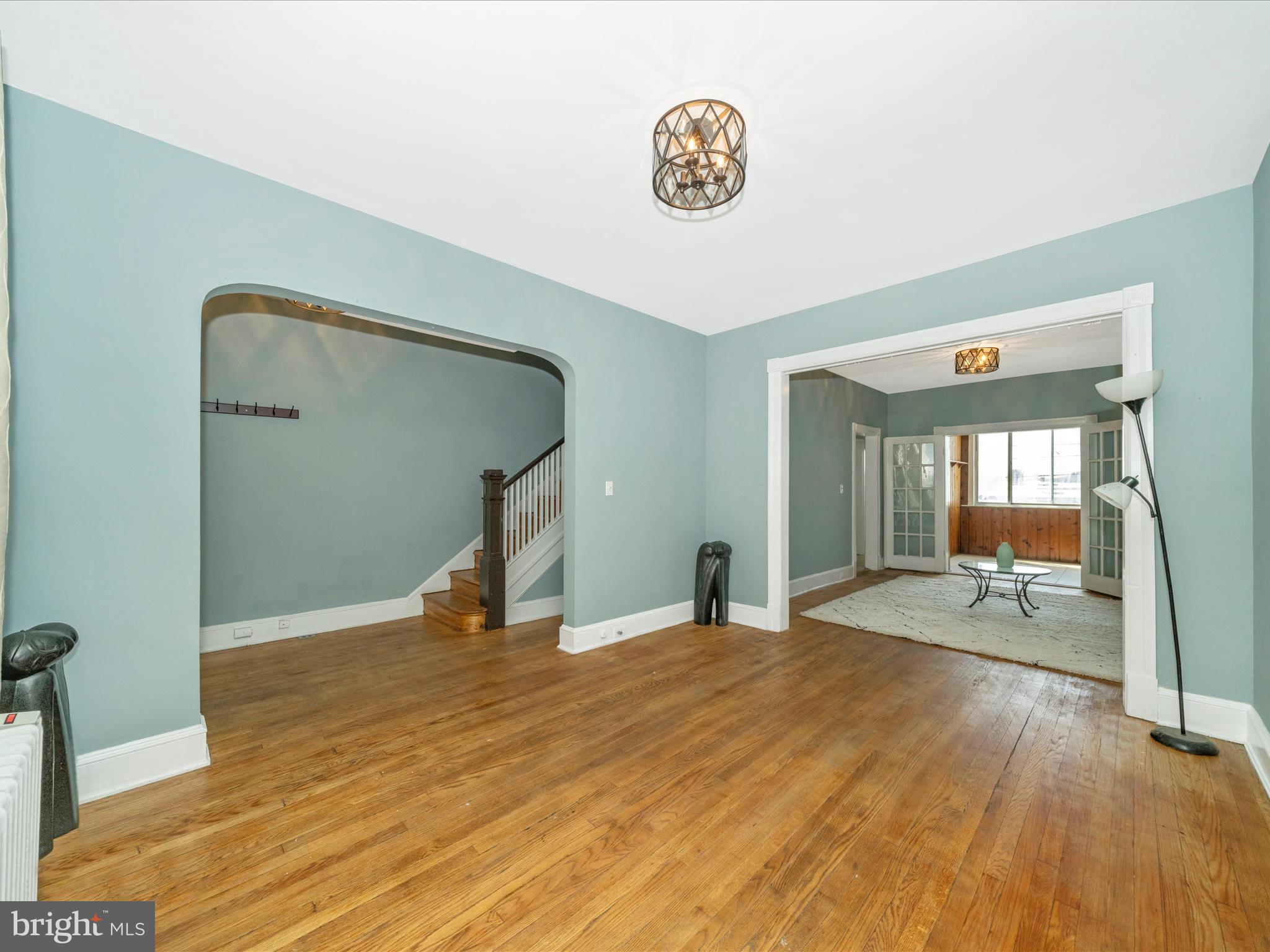4818 7th Street Northwest Washington, DC 20011 - Photo 3 of 31 a bedroom with a bed and a table with wooden floor