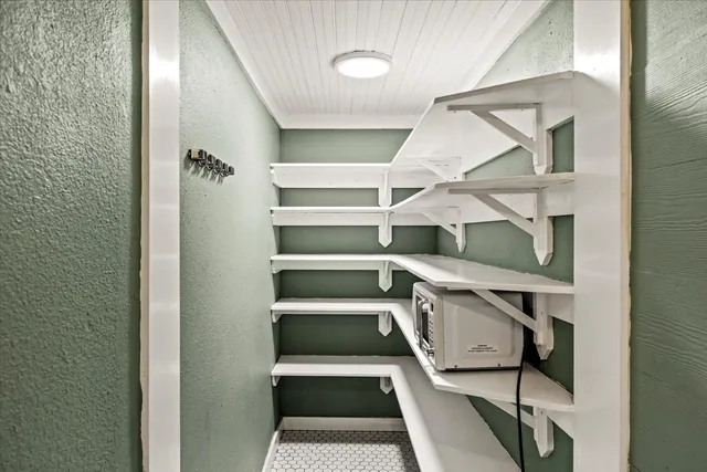 a utility room with mirror and window