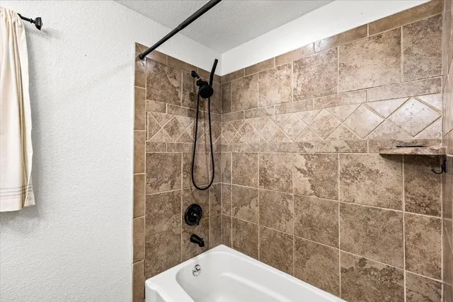 a bathroom with a bathtub and shower
