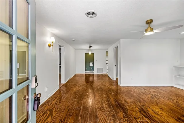 a view of hallway with wooden floor