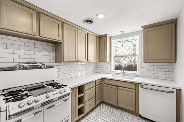a kitchen with a sink stove top oven and cabinets
