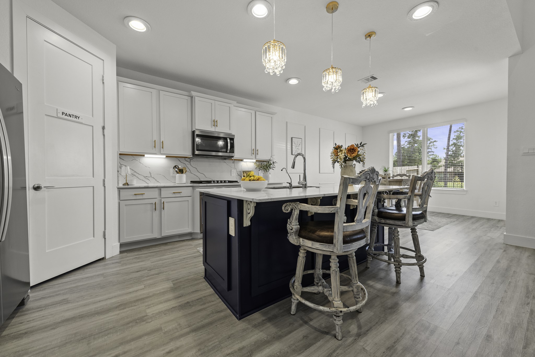 14130 Savage River Conroe, TX 77384 - Photo 12 of 33 a kitchen with a dining table chairs and refrigerator