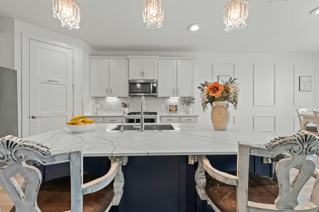 a kitchen with a table chairs and a stove