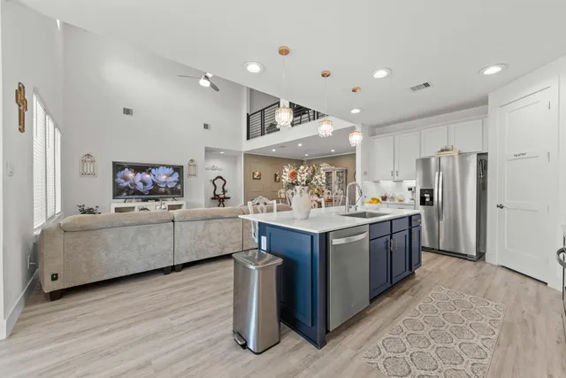 a kitchen with stainless steel appliances kitchen island granite countertop a refrigerator a sink and a stove