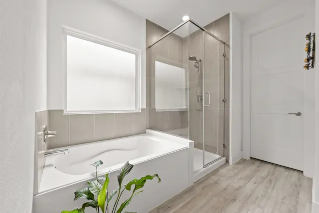 a bathroom with a tub and shower