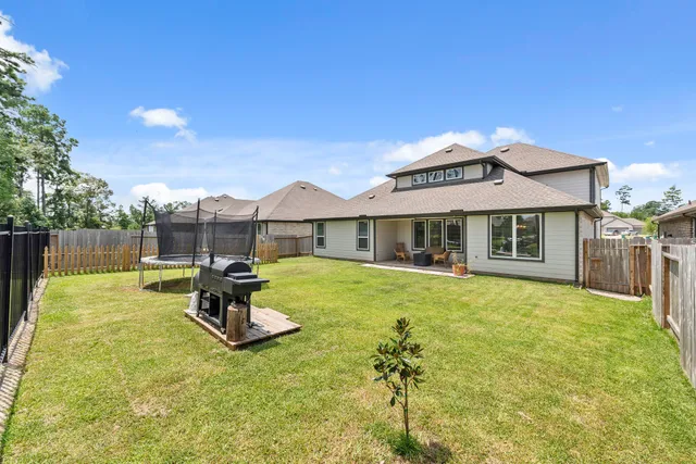 a front view of a house with swimming pool having outdoor seating