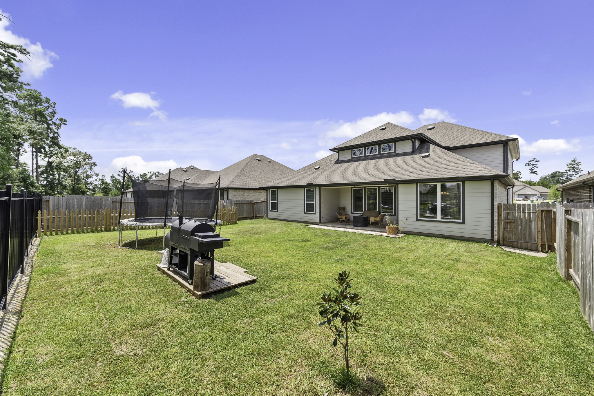 14130 Savage River Conroe, TX 77384 - Photo 32 of 33 a front view of a house with swimming pool having outdoor seating
