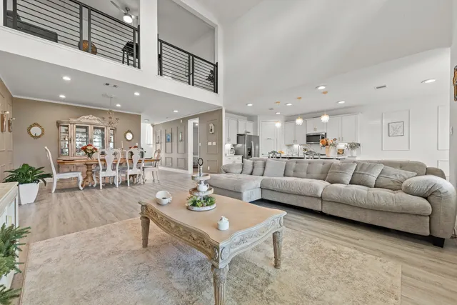 a living room with furniture kitchen view and a table