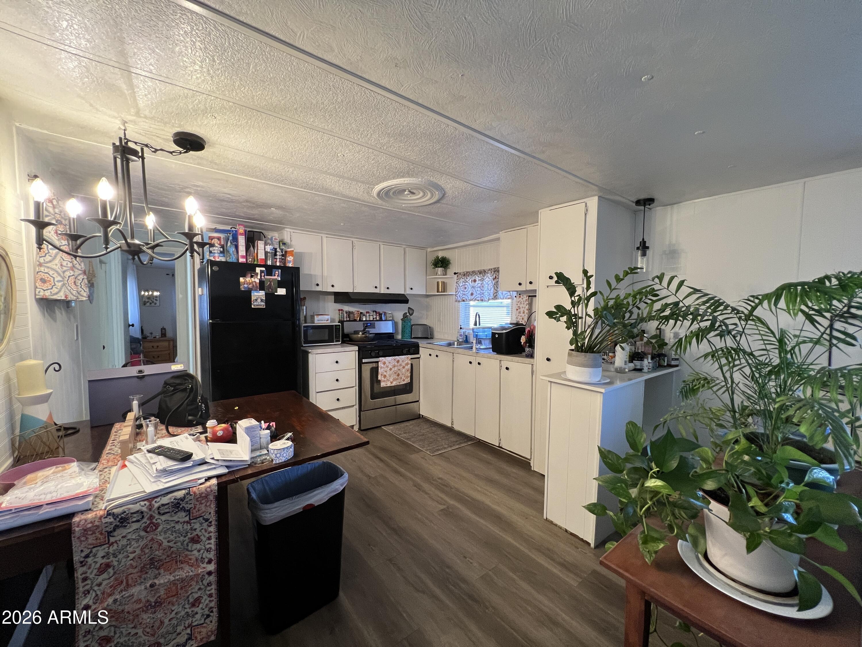 19225 North Cave Creek Road, Unit 40 Phoenix, AZ 85024 - Photo 10 of 21 a kitchen with granite countertop a refrigerator and stove