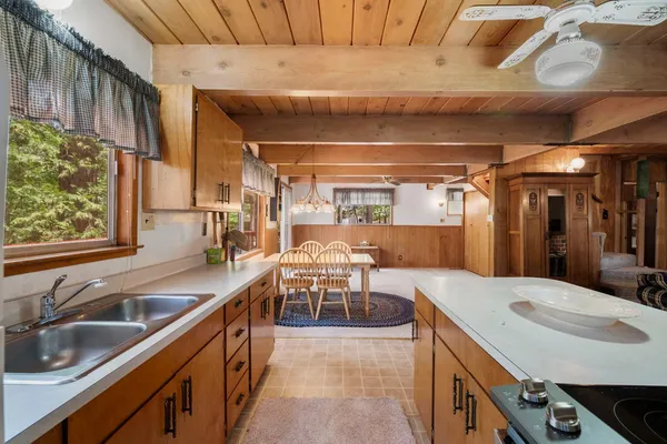 a kitchen with a sink a counter top space and appliances