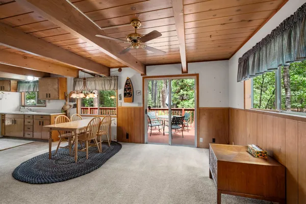 a dining room with furniture a rug and a chandelier
