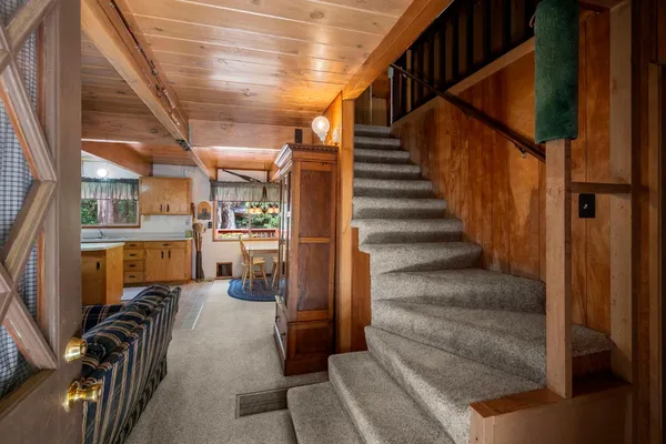 a view of entryway and hall with wooden floor