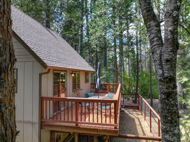 a view of house with roof deck and furniture