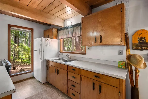 a kitchen with a sink a stove and a refrigerator
