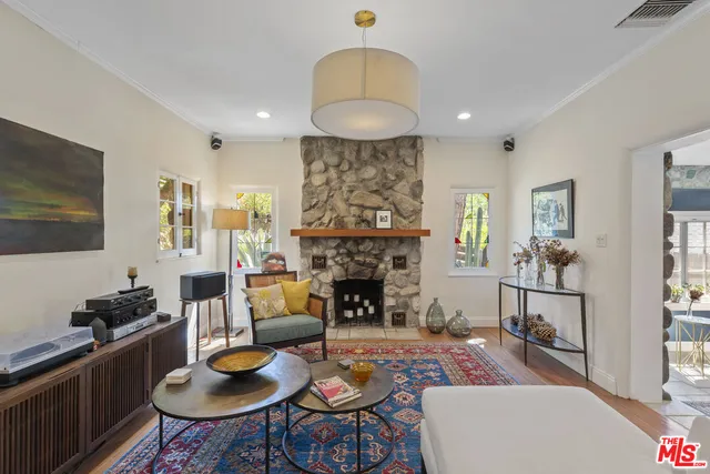 a living room with furniture a fireplace and a flat screen tv