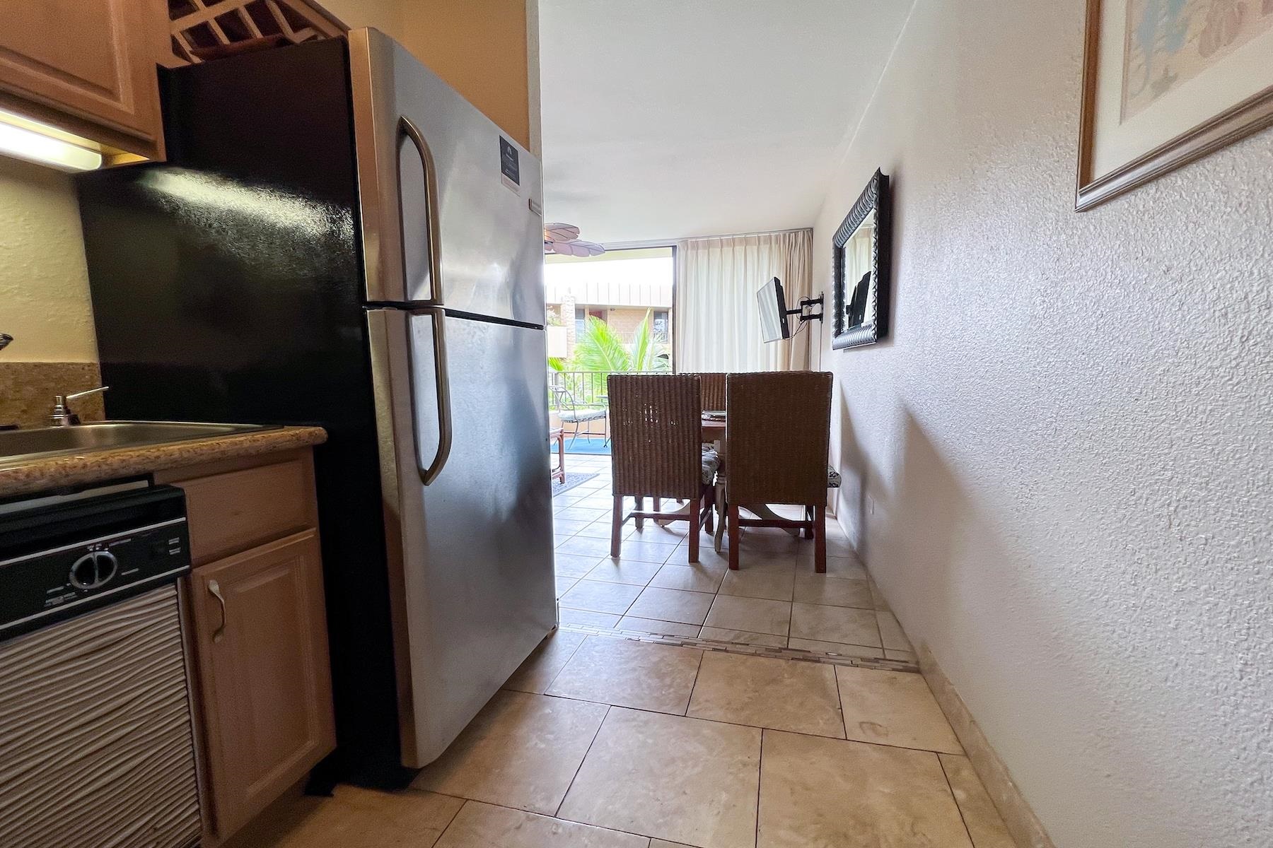 3601 Lower Honoapiilani Road, Unit 414 Lahaina, HI 96761 - Photo 11 of 28 a kitchen with stainless steel appliances granite countertop a refrigerator and a stove top oven