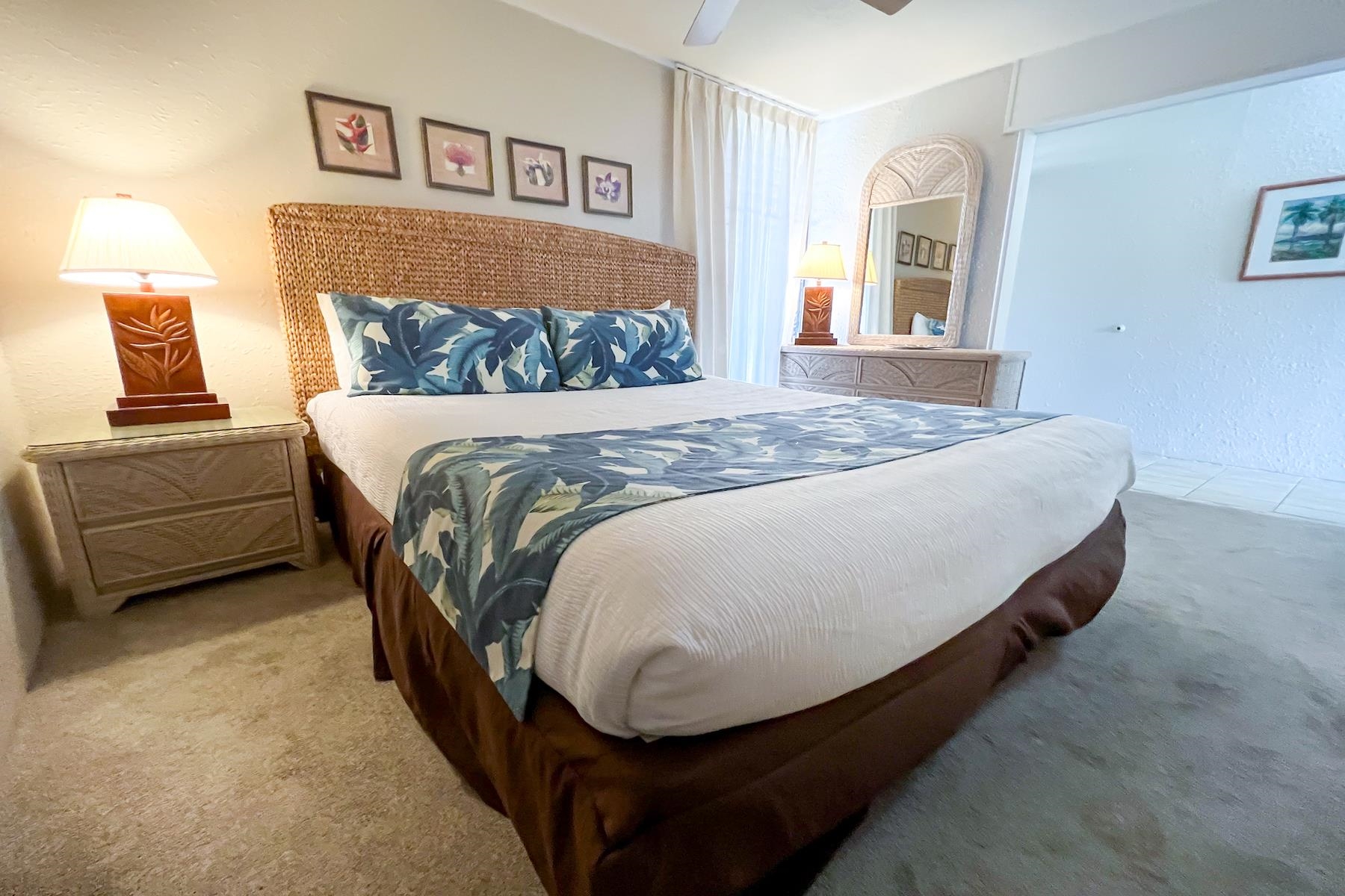 3601 Lower Honoapiilani Road, Unit 414 Lahaina, HI 96761 - Photo 12 of 28 a bed sitting in a bedroom and painting on the wall