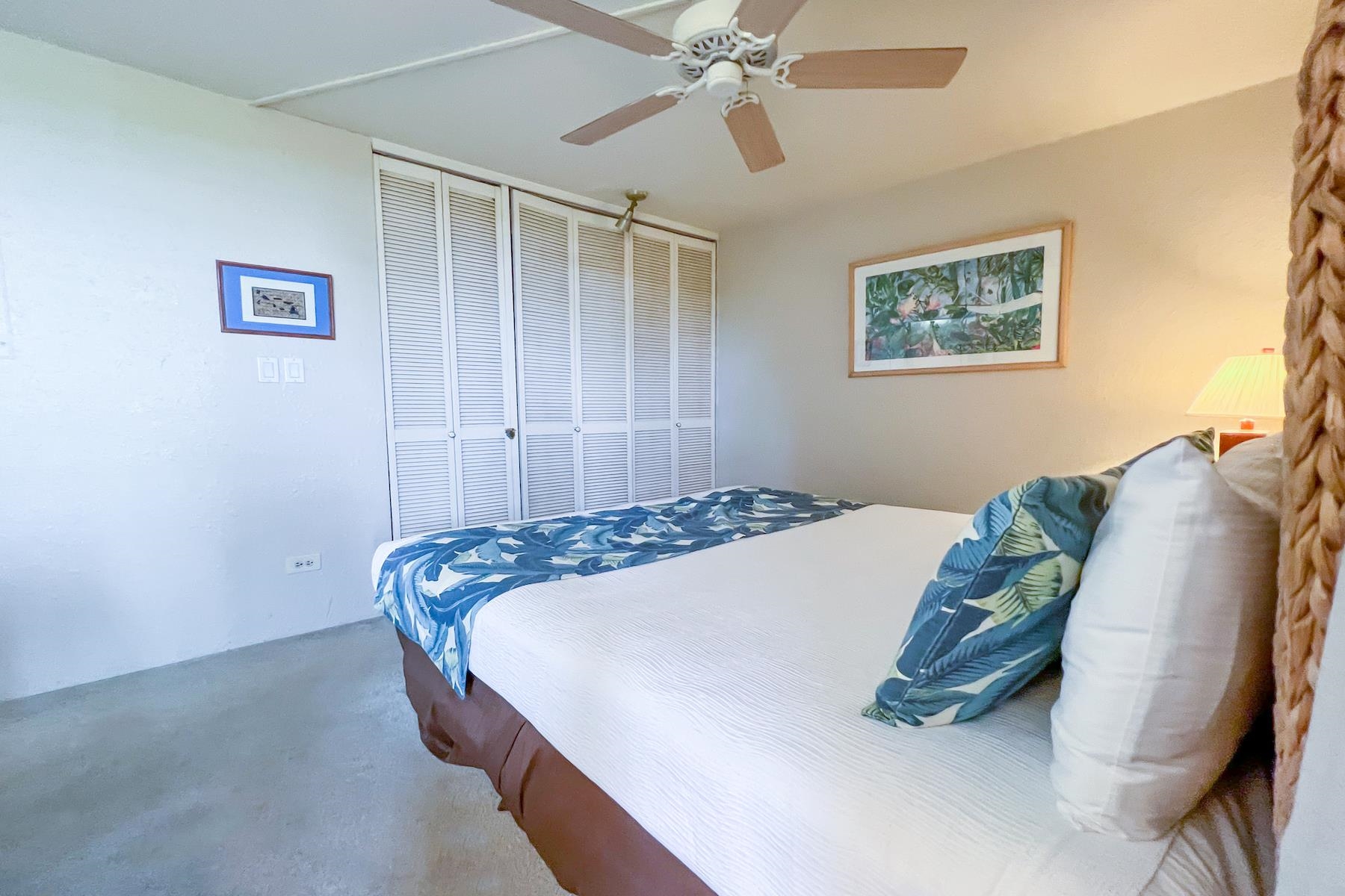 3601 Lower Honoapiilani Road, Unit 414 Lahaina, HI 96761 - Photo 13 of 28 a bedroom with a bed and a painting on the wall