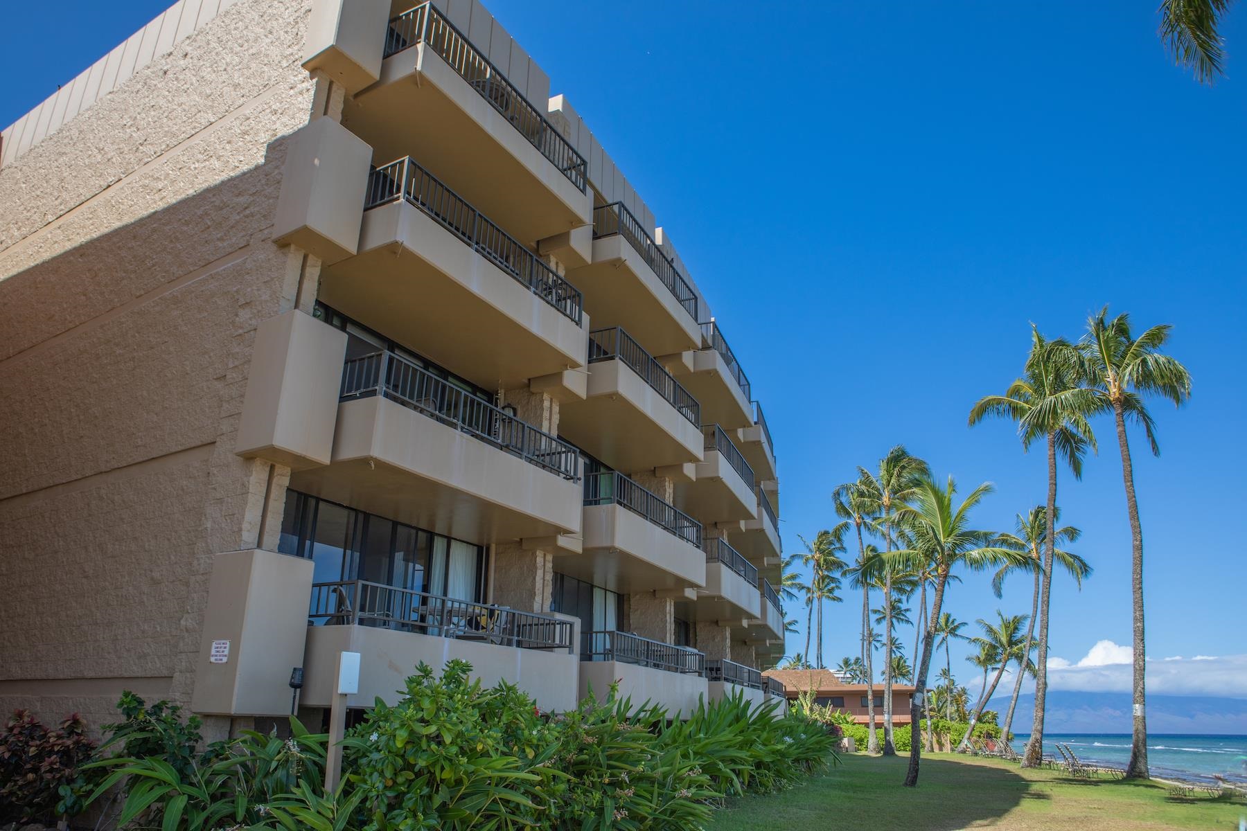 3601 Lower Honoapiilani Road, Unit 414 Lahaina, HI 96761 - Photo 2 of 28 a front view of a house with a yard