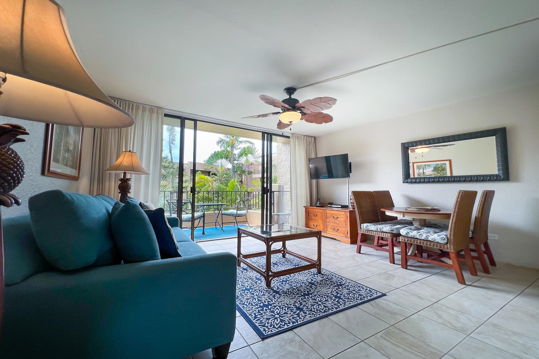3601 Lower Honoapiilani Road, Unit 414 Lahaina, HI 96761 - Photo 5 of 28 a living room with furniture a lamp a rug and a large window