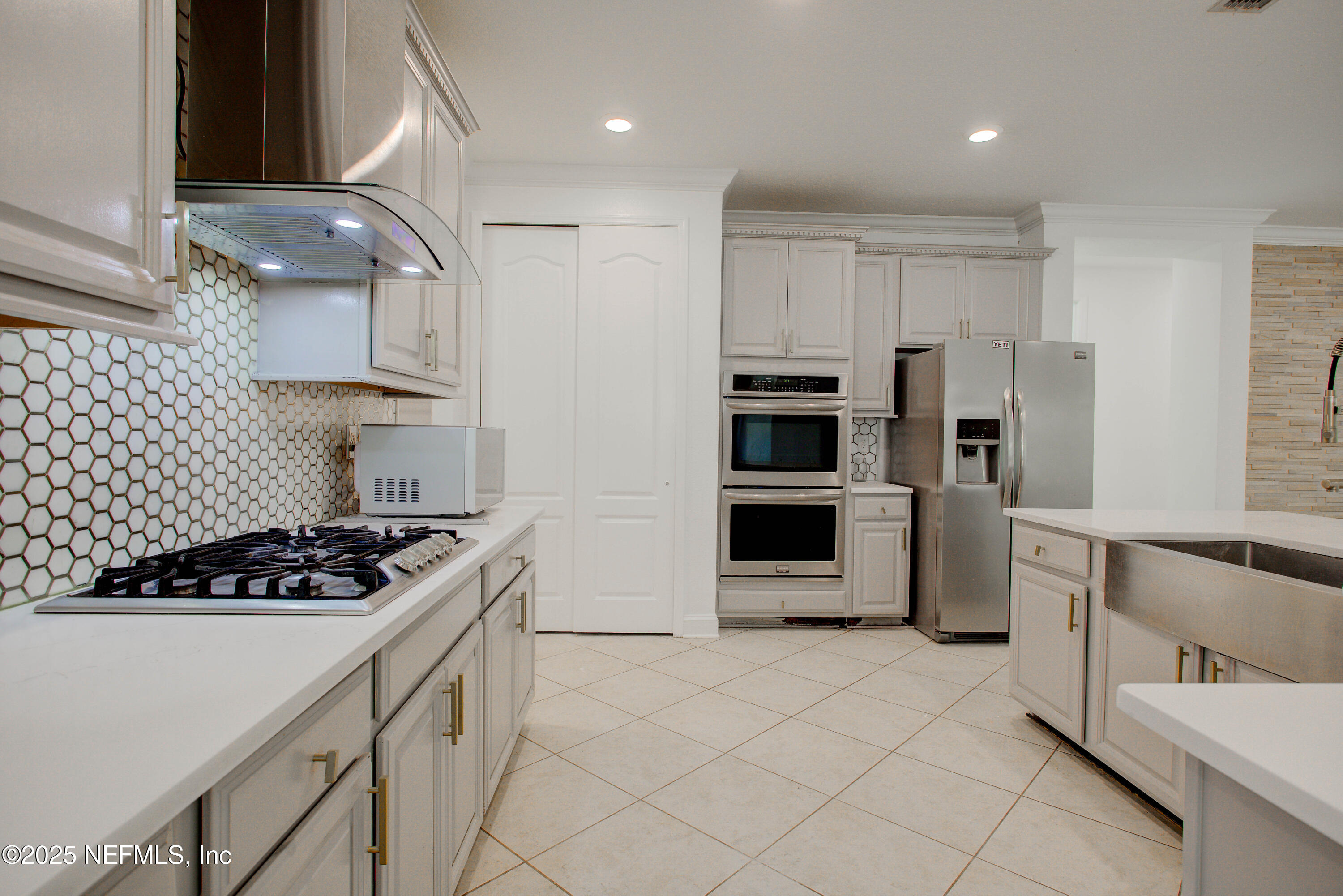 174 Antilles Road St. Augustine, FL 32092 - Photo 29 of 88 a kitchen with stainless steel appliances a stove a microwave and a refrigerator
