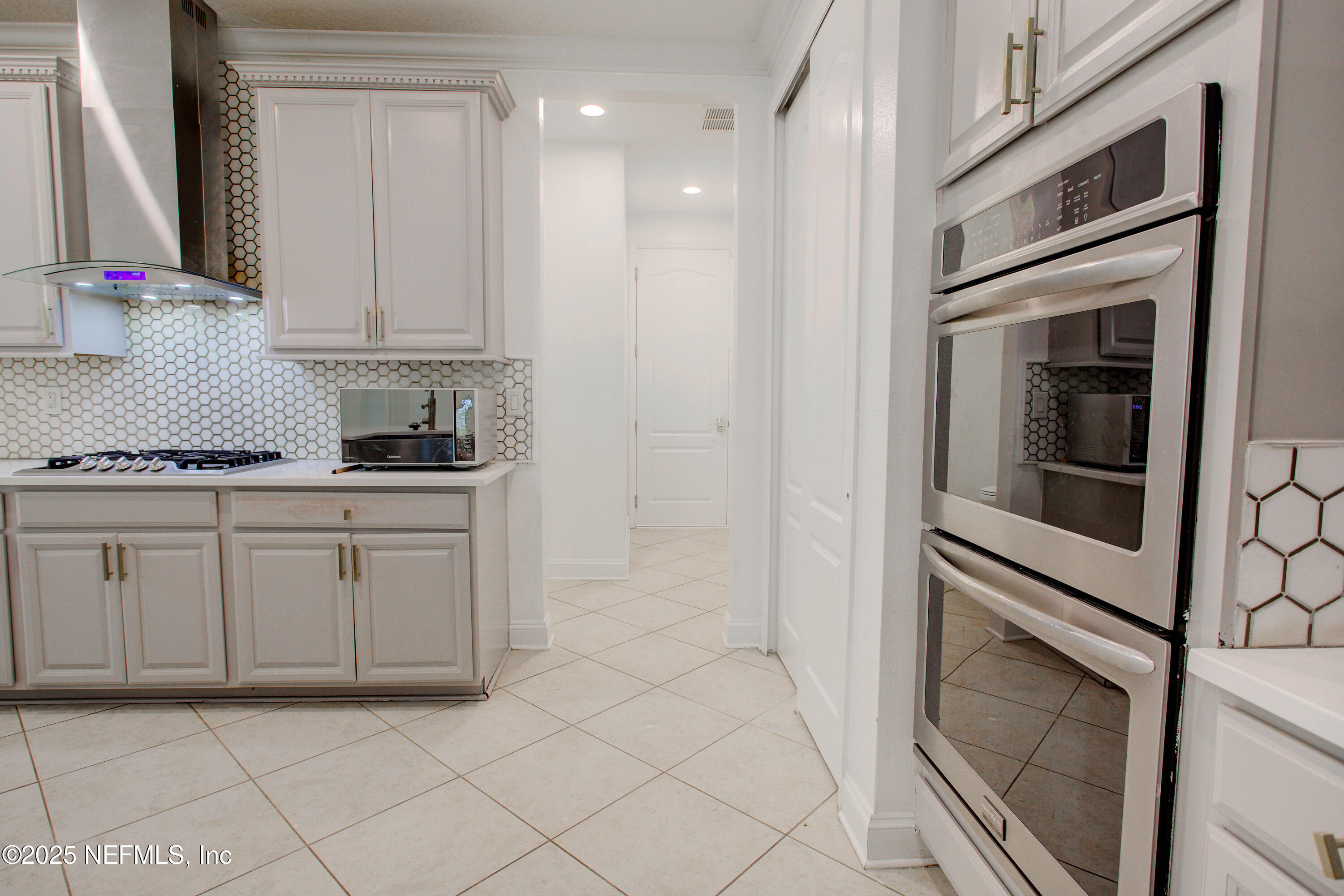 174 Antilles Road St. Augustine, FL 32092 - Photo 37 of 88 a kitchen with white cabinets and white appliances