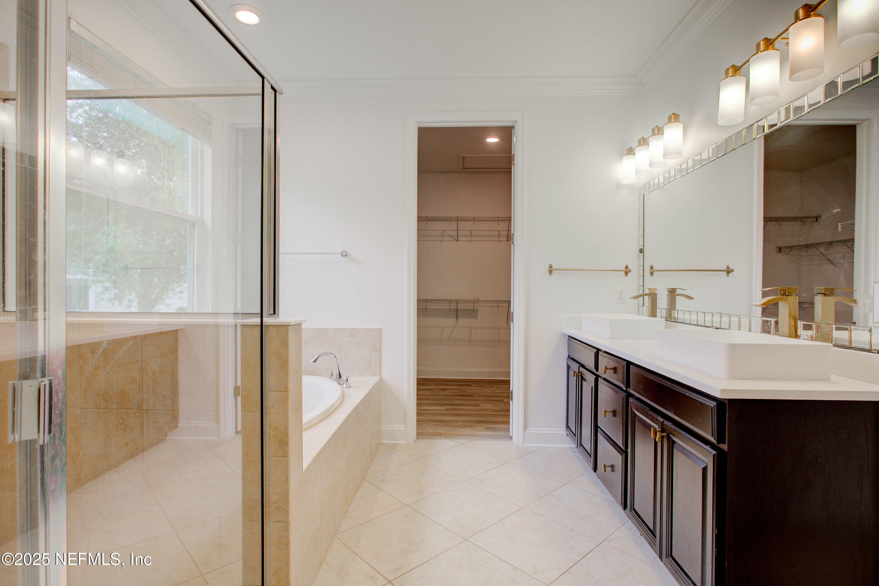 174 Antilles Road St. Augustine, FL 32092 - Photo 54 of 88 a spacious bathroom with a double vanity sink a mirror and a shower