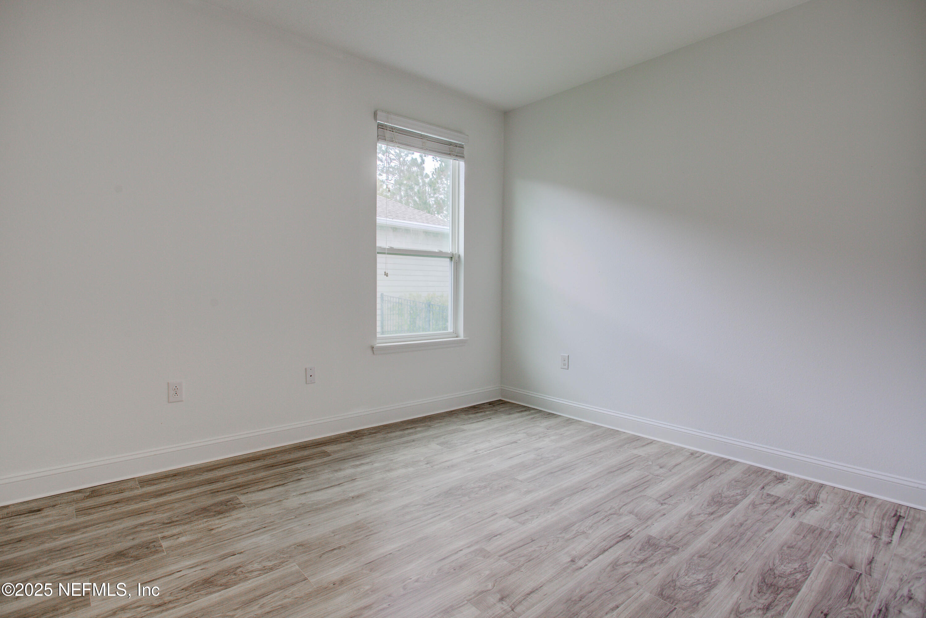 174 Antilles Road St. Augustine, FL 32092 - Photo 67 of 88 an empty room with wooden floor and windows