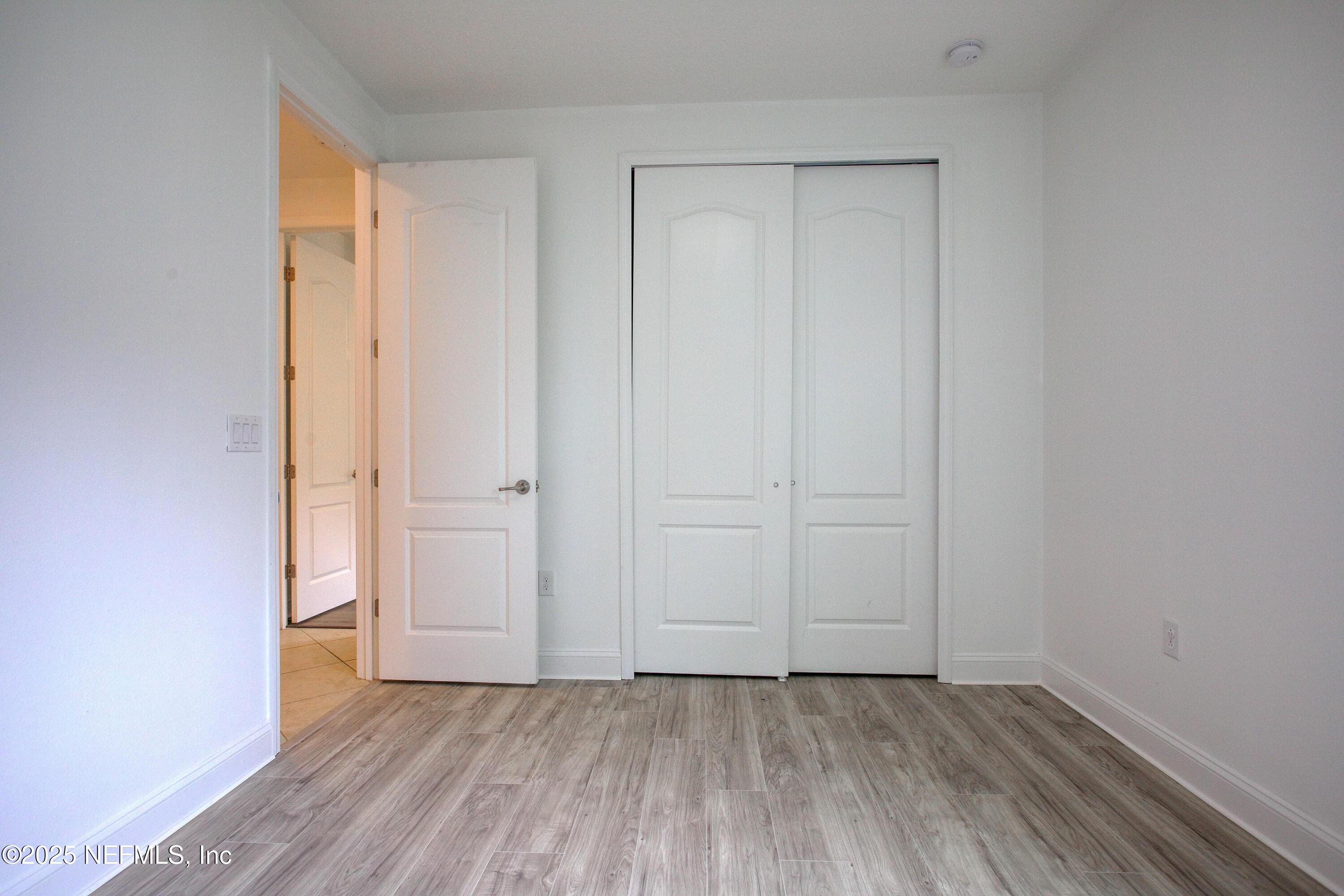 174 Antilles Road St. Augustine, FL 32092 - Photo 69 of 88 an empty room with wooden floor and closet area