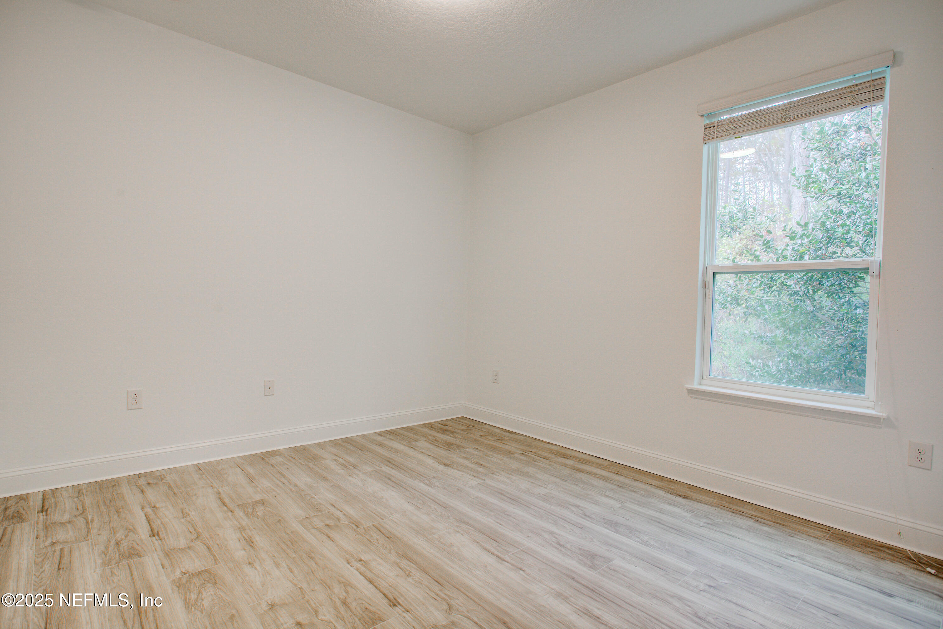 174 Antilles Road St. Augustine, FL 32092 - Photo 74 of 88 an empty room with wooden floor and windows
