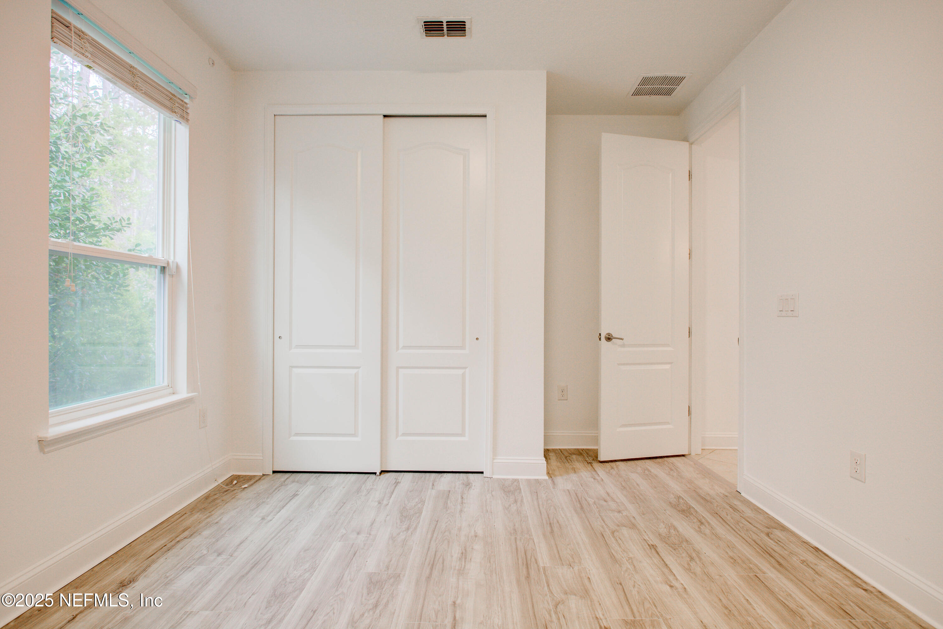 174 Antilles Road St. Augustine, FL 32092 - Photo 76 of 88 an empty room with wooden floor and windows