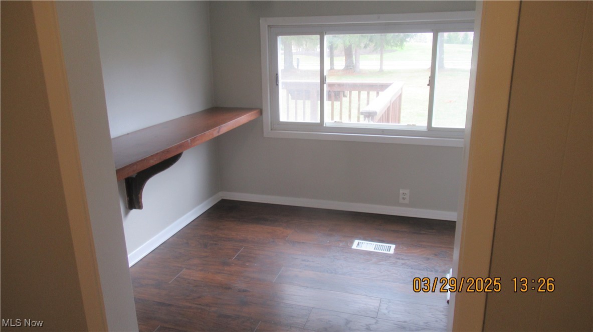 36505 Pettibone Road Solon, OH 44139 - Photo 12 of 24 Empty room featuring dark wood finished floors, baseboards, and visible vents
