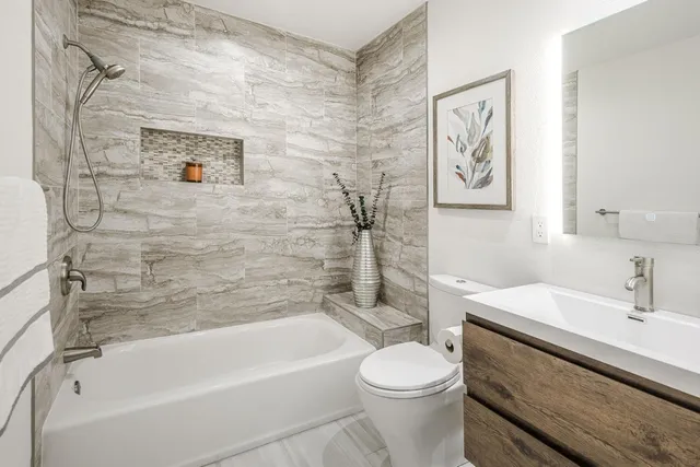 a bathroom with a sink toilet and bathtub