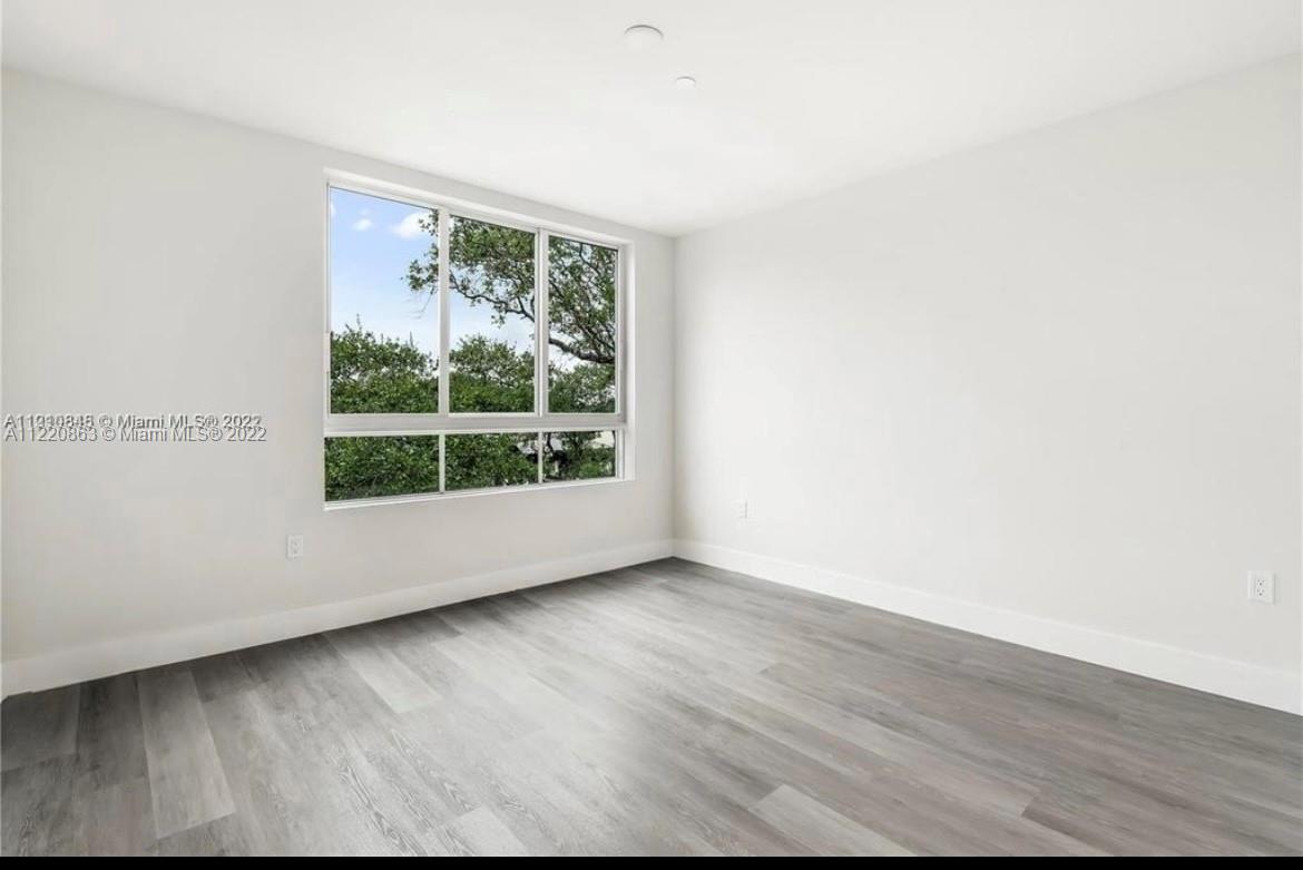 Ojus Miami, FL 33180 - Photo 5 of 10 a view of room with window and wooden floor